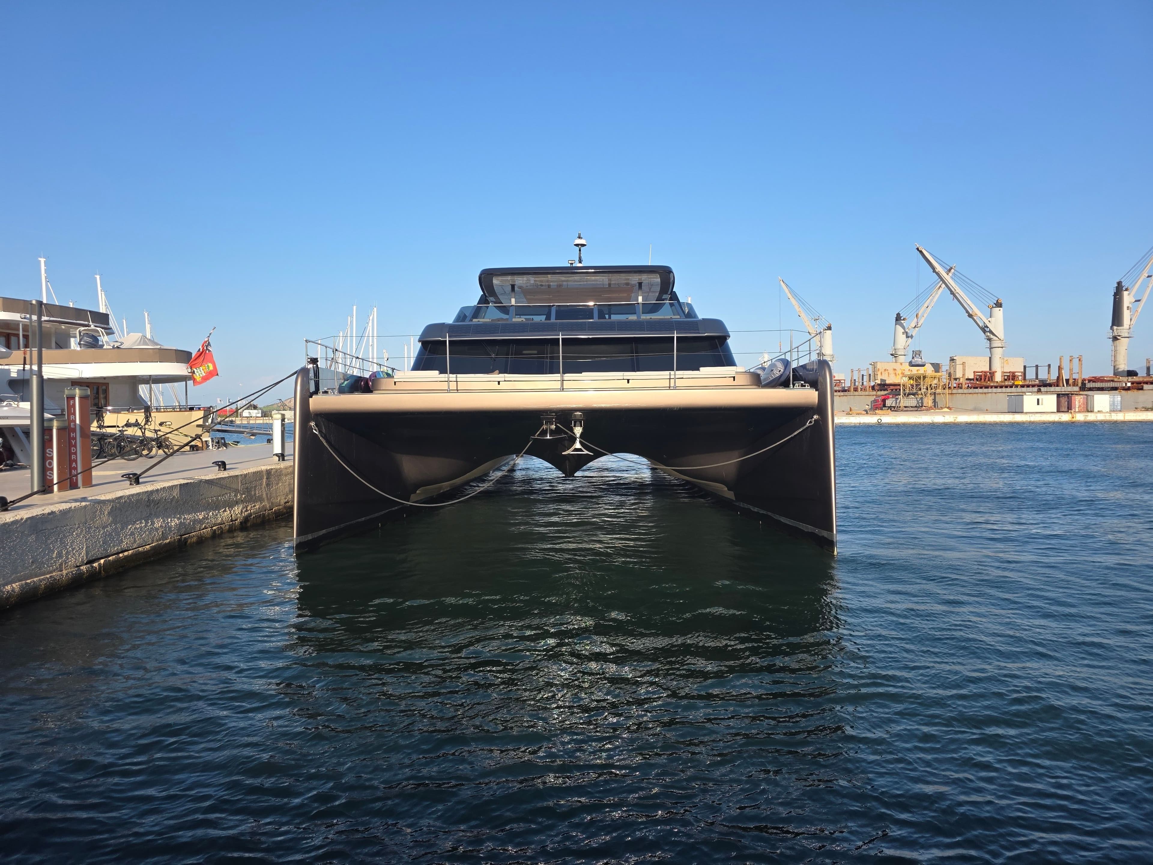 Twin outboard engines on a boat's transom, its wake running away astern